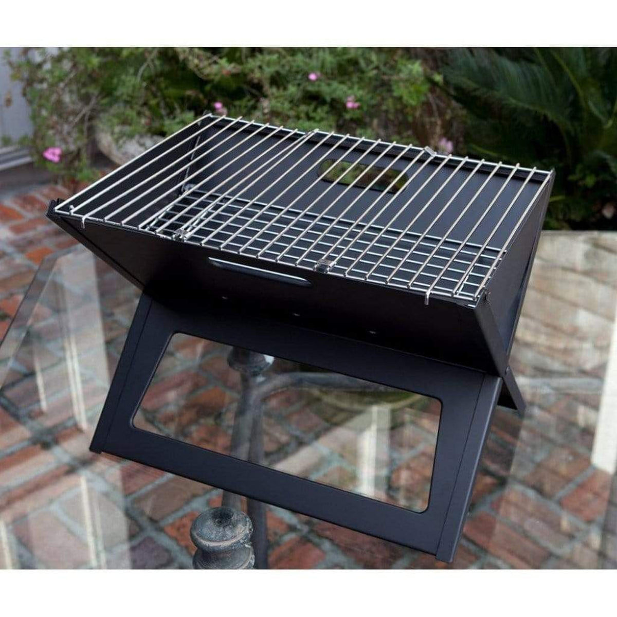 Fire Sense Notebook portable charcoal grill folded open on a table – view 11